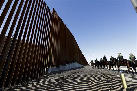 Migrants queue near the border fence, after crossing the Rio Bravo river, to request asylum in El Paso, Texas, as seen from Ciudad Juarez, Mexico, Jan. . Mexico border near me